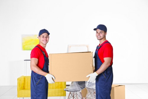 Removal team preparing house removals in Kingston Vale with packed boxes
