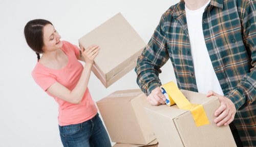 Office relocation planning in Kingston Vale with moving team and packed boxes