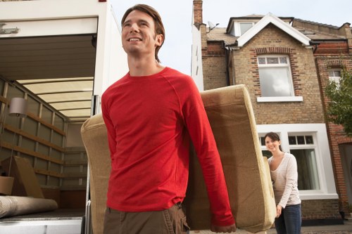 Piano moving service planning access and loading outside a Kingston Vale home