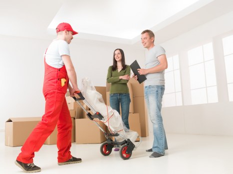 Furniture being carried from a residential property in Kingston Vale